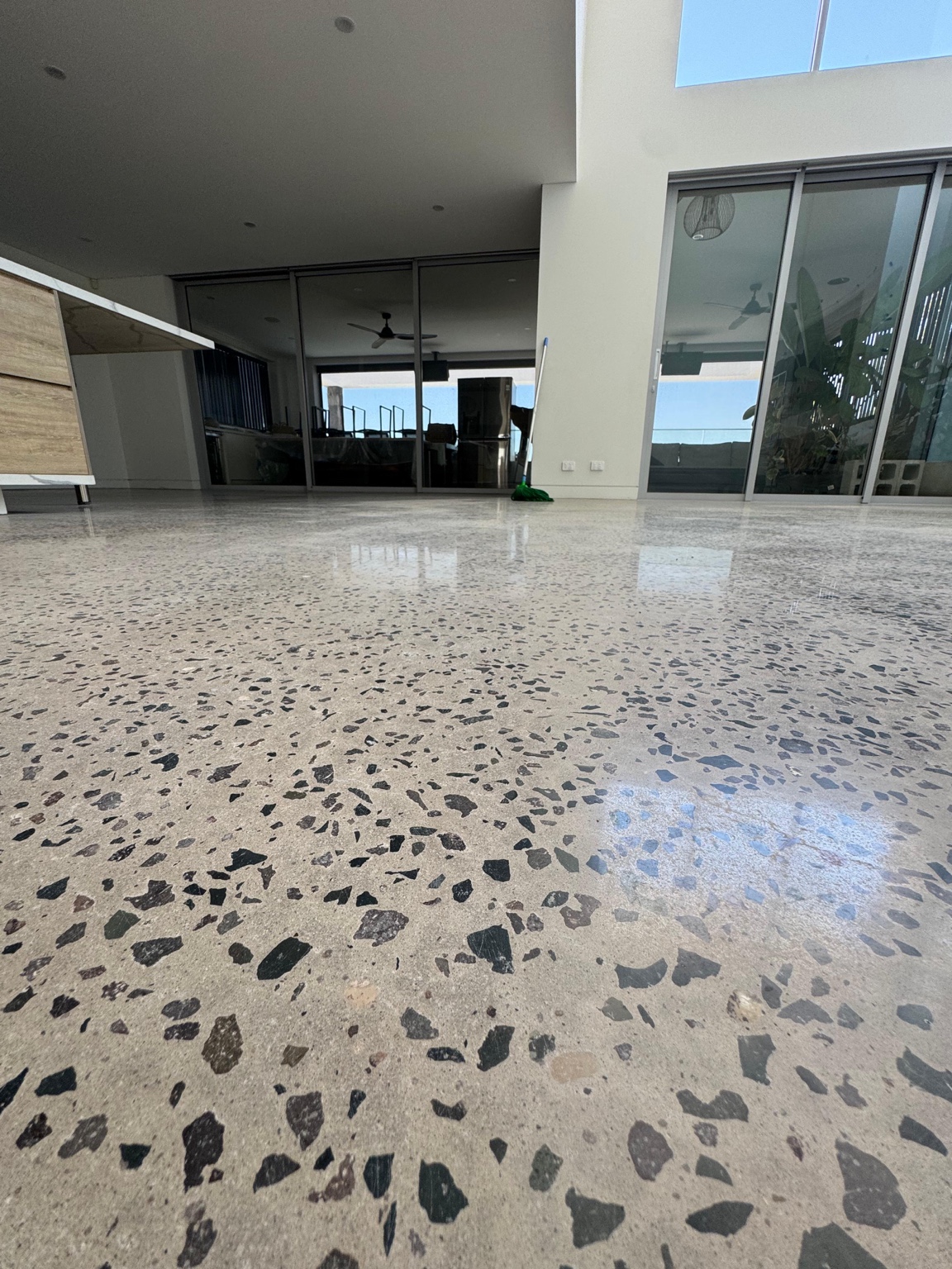Real polished concrete floor with exposed aggregate in a residential interior
